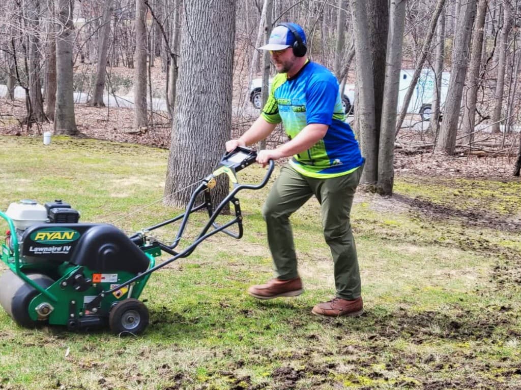 Core aeration in progress with a Ryan Lawnaire IV on a Midland lawn