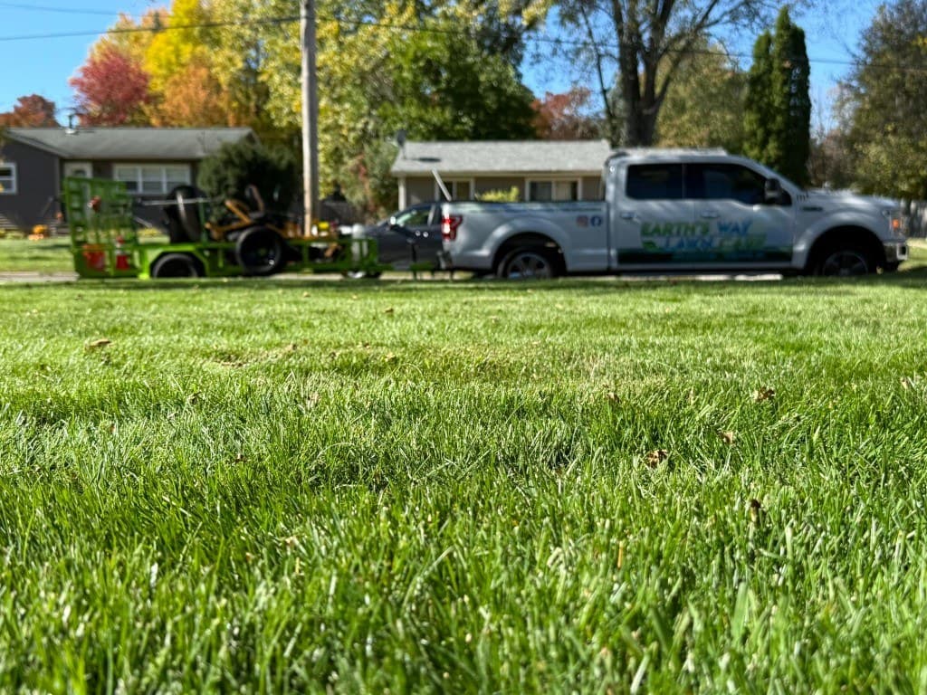 Earth's Way truck and trailer beside a healthy Midland lawn