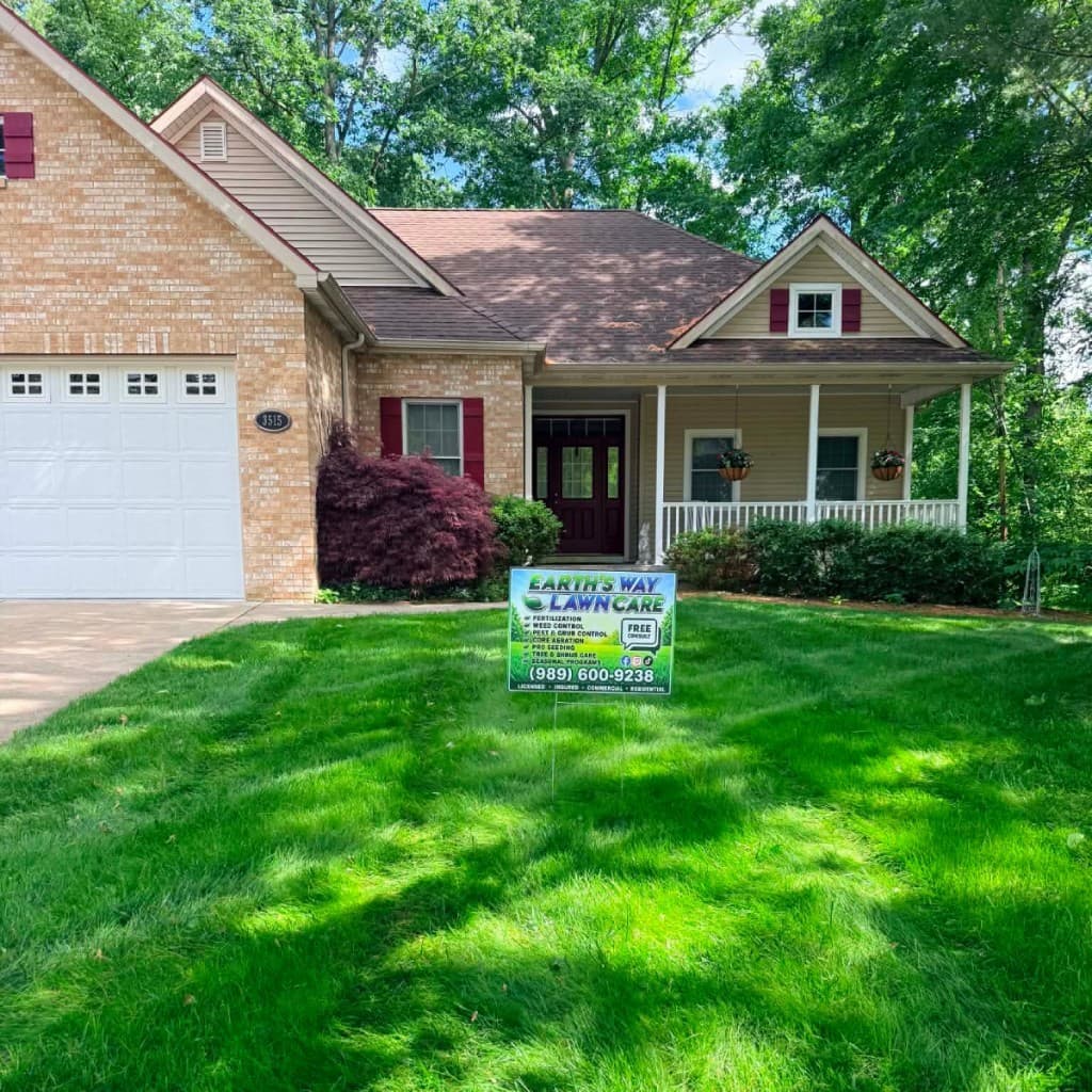 Weed-free lawn with Earth's Way Lawn Care yard sign